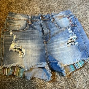 Super cute jean shorts with colored pockets that hang down.